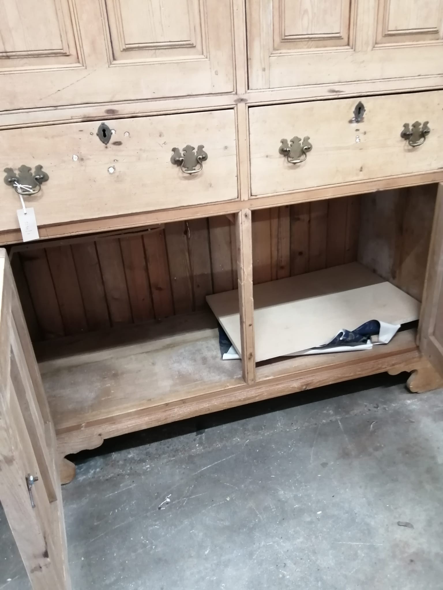 An early 19th century pine household cupboard, width 150cm, depth 65cm, height 196cm (cornice in need of repair / piece present).